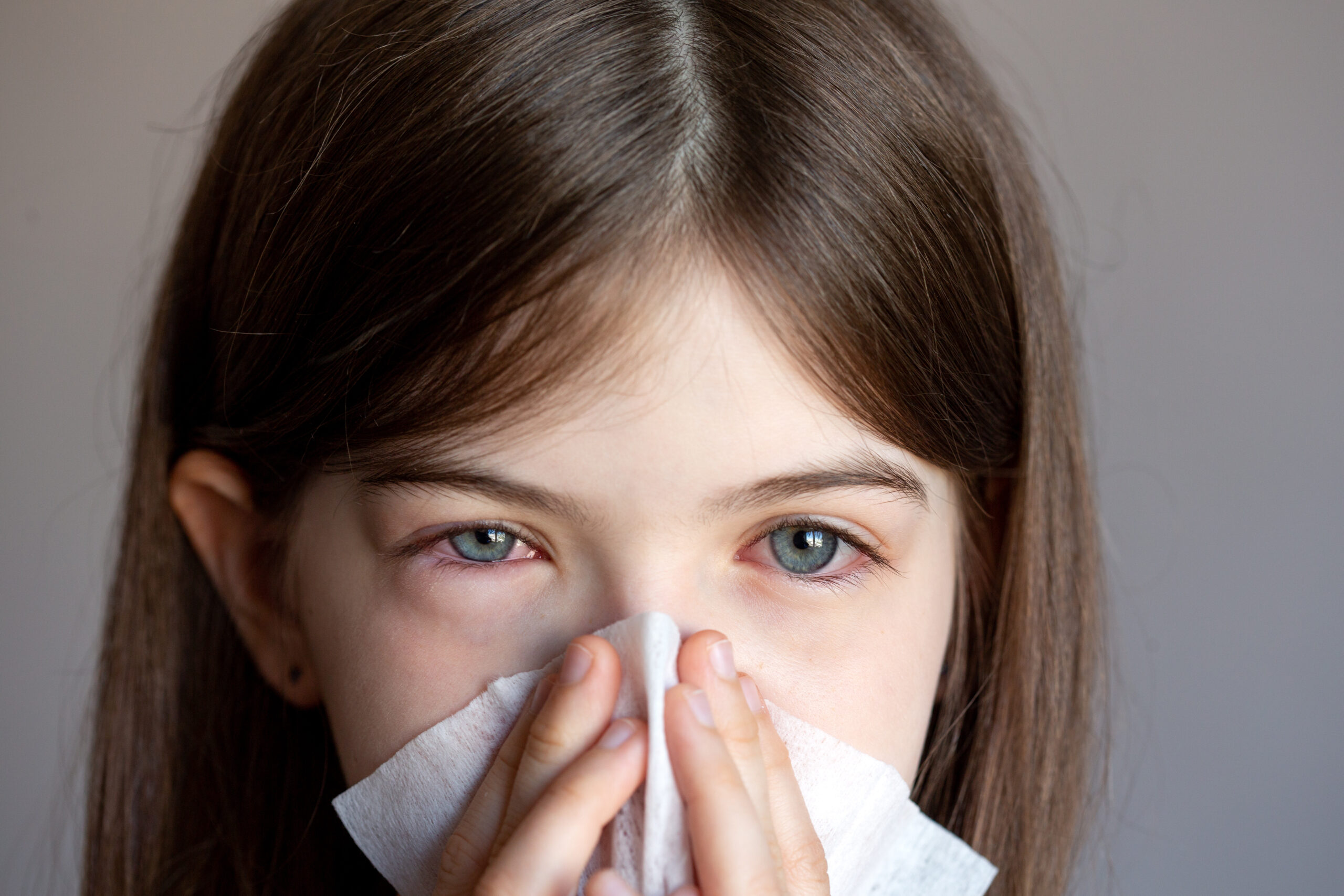The,young,girl,is,allergic,,she,blows,her,nose,in